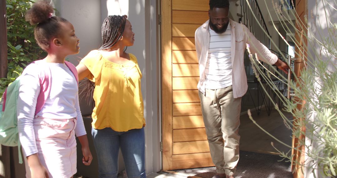 Family Welcome Home with Warm Smiles at Doorway