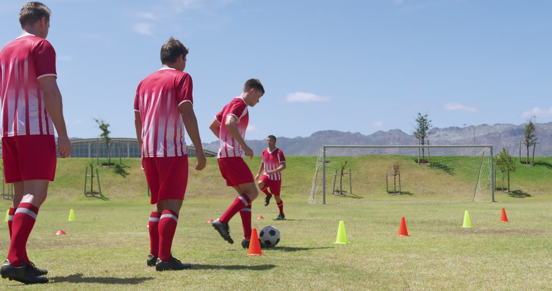 Soccer players practicing dribbling skills during training session outdoors - Free Images, Stock Photos and Pictures on Pikwizard.com