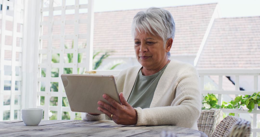 Senior Woman Using Tablet on Patio - Free Images, Stock Photos and Pictures on Pikwizard.com