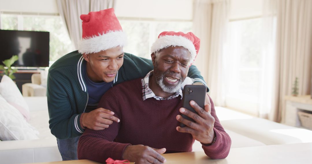 Father and Son Celebrating Christmas on Video Call - Free Images, Stock Photos and Pictures on Pikwizard.com