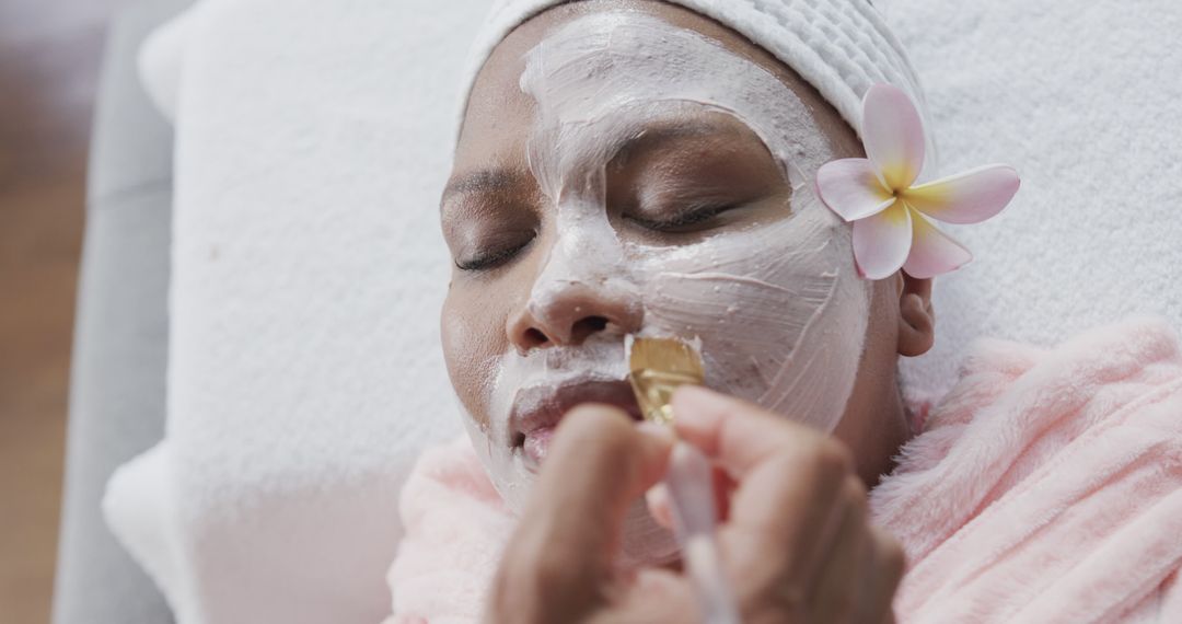 Woman Receiving Facial Mask Spa Treatment with Flower Decoration - Free Images, Stock Photos and Pictures on Pikwizard.com