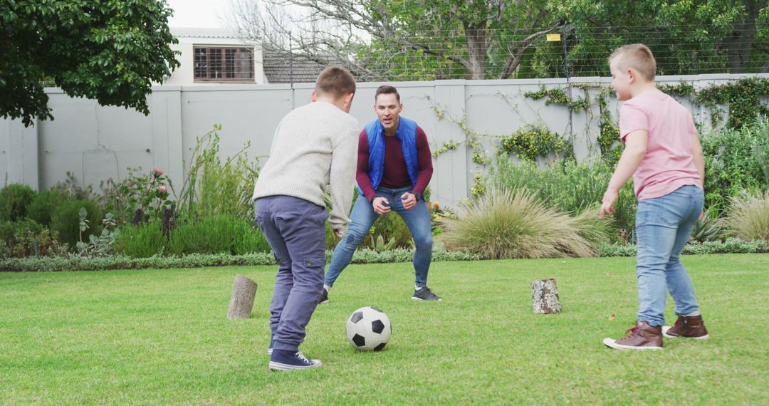 Father Playing Soccer with Two Sons in Backyard - Free Images, Stock Photos and Pictures on Pikwizard.com