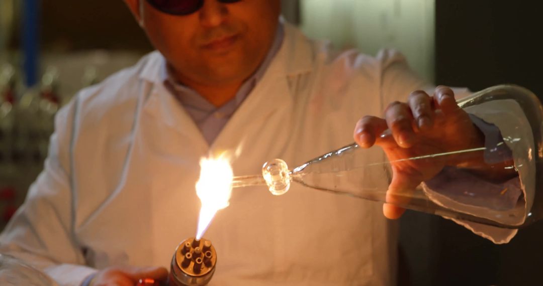 Technician Crafting Glass with Torch in Lab Workshop