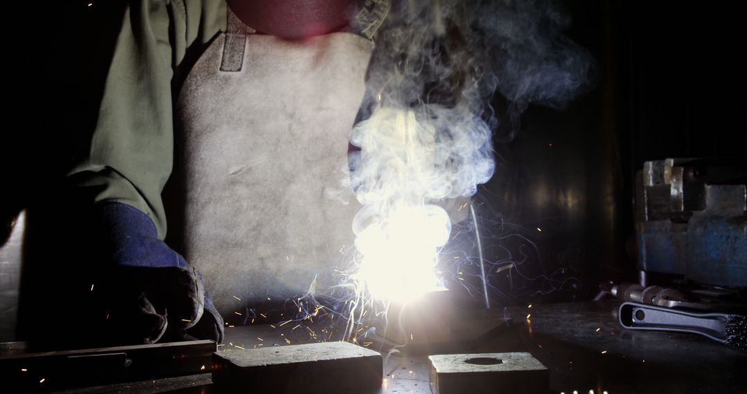 Welder Working in Industrial Environment with Bright Spark in Dark Room - Free Images, Stock Photos and Pictures on Pikwizard.com