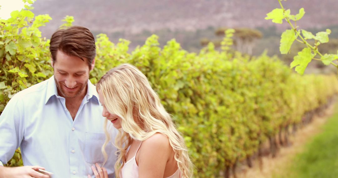 A young Caucasian couple enjoys a moment together in a vineyard, with copy space - Free Images, Stock Photos and Pictures on Pikwizard.com