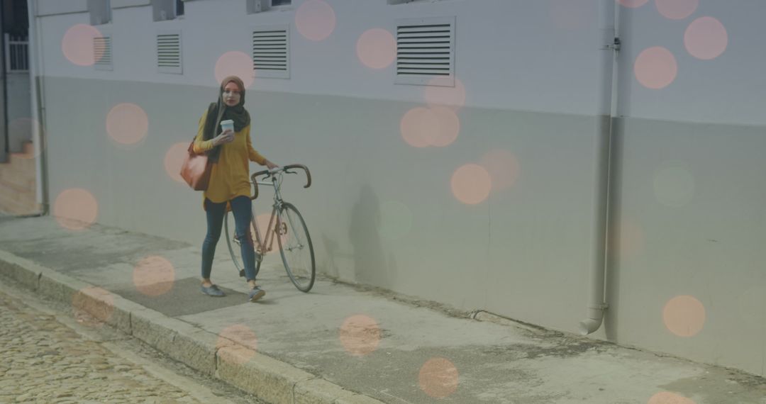 Woman Walking with Bicycle and Bright Bokeh Lights