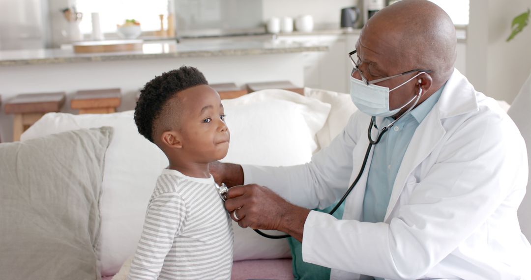 African American Doctor Examining Young Child with Stethoscope at Home - Free Images, Stock Photos and Pictures on Pikwizard.com