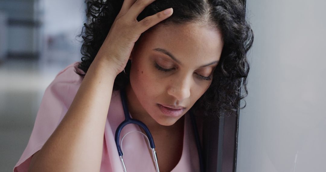 Stressed Female Doctor in Hospital Setting with Stethoscope - Free Images, Stock Photos and Pictures on Pikwizard.com