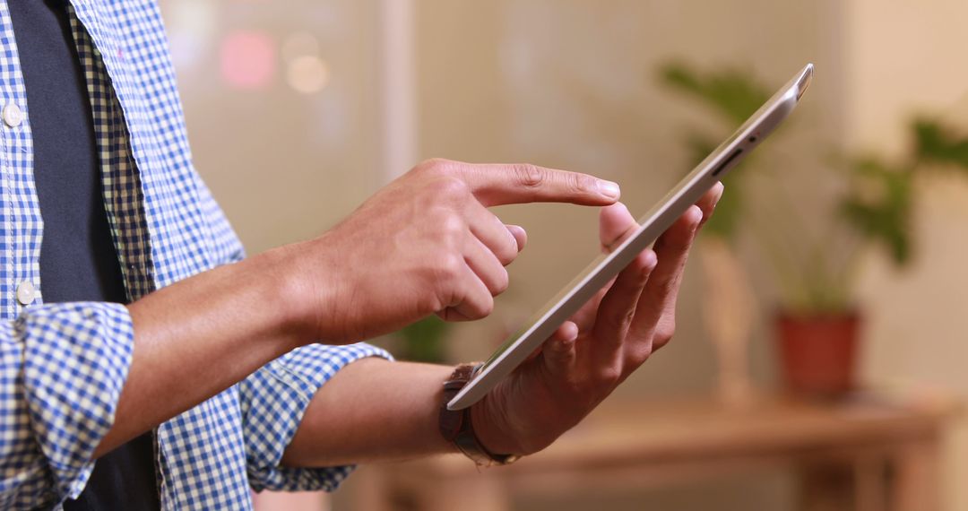 Hands Using Tablet in Modern Home Office Environment
