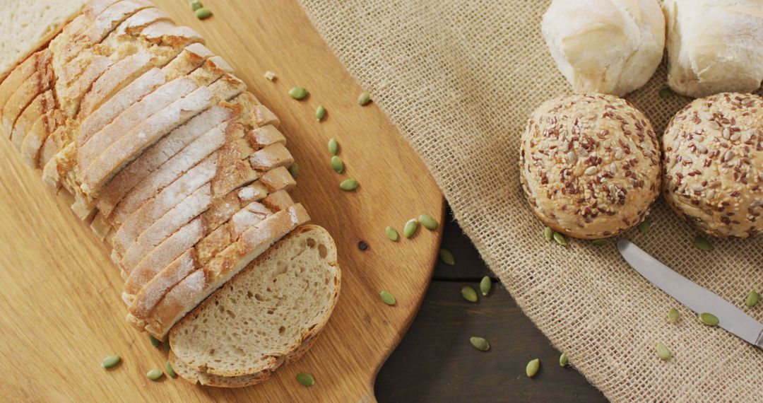 Assorted Fresh Bread Loaves and Rolls on Table