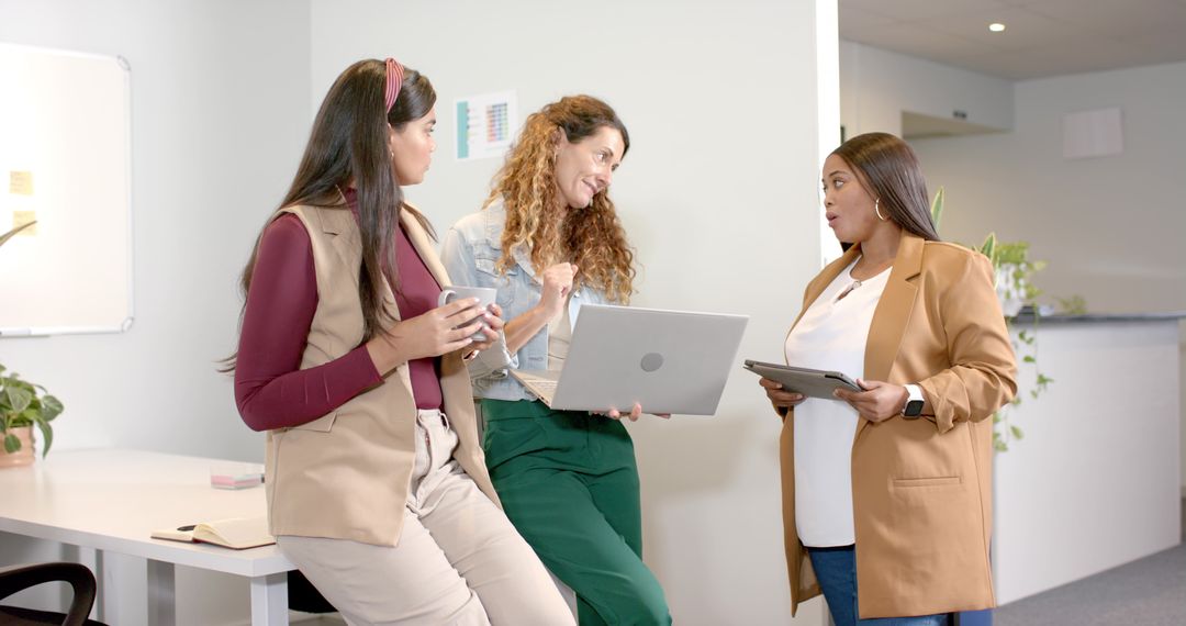Diverse Women Communicating in Modern Office Environment