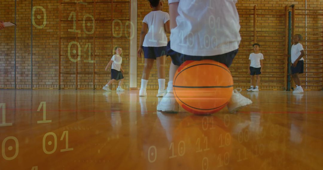 Children Practicing Basketball Skills Indoors with Focus on Teamwork
