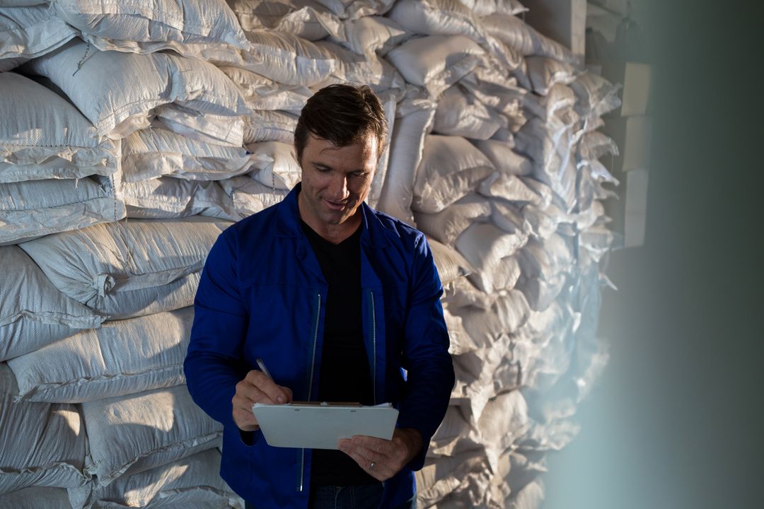 Warehouse Supervisor Conducting Inventory Check with Clipboard