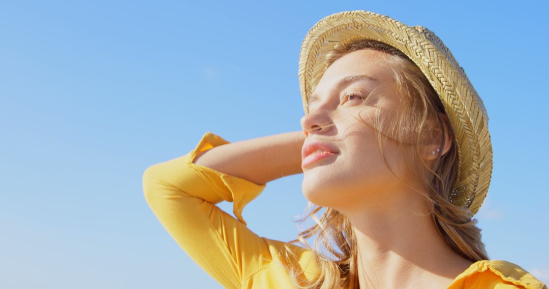 Young Woman Enjoying Sunny Day Wearing Straw Hat - Free Images, Stock Photos and Pictures on Pikwizard.com