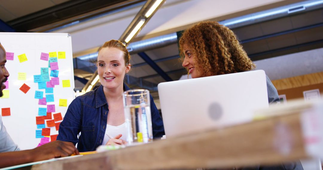 Diverse Team Brainstorming in Modern Office with Sticky Notes