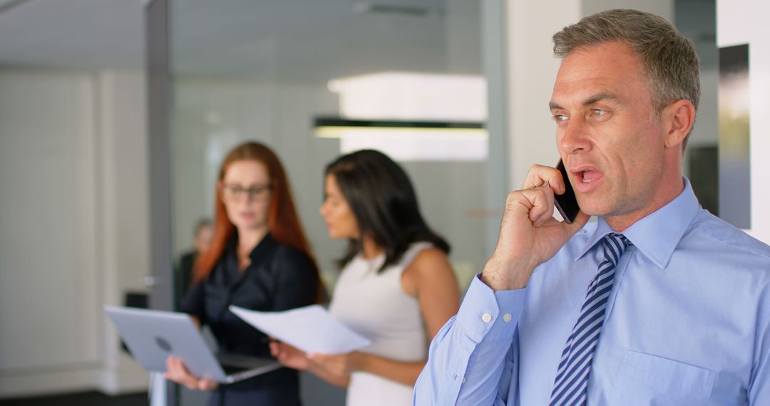 Professional Businessman on Phone Call in Modern Office - Free Images, Stock Photos and Pictures on Pikwizard.com