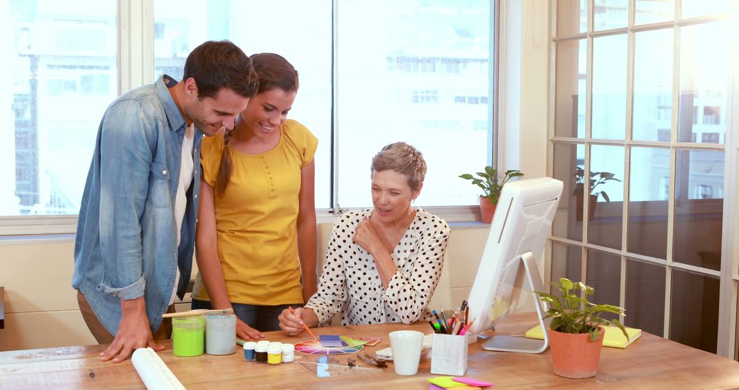 Creative Team Collaborating on Project at Office Desk - Free Images, Stock Photos and Pictures on Pikwizard.com