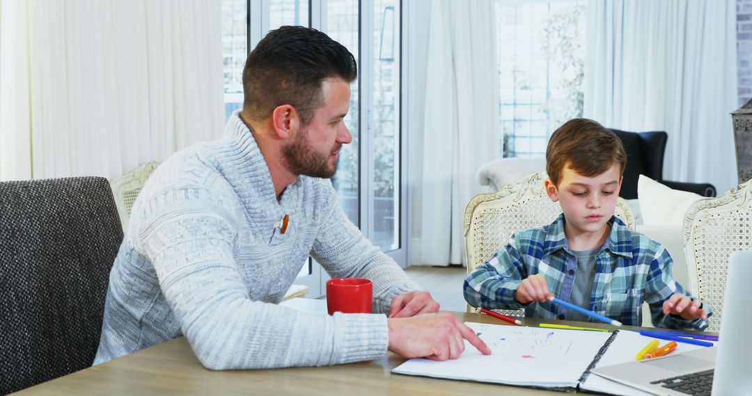 Father Helping Young Son with Homework at Home - Free Images, Stock Photos and Pictures on Pikwizard.com