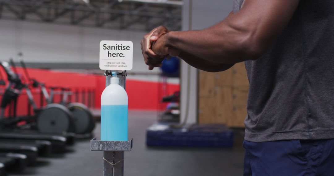 Man Using Hand Sanitizer Station in Gym - Free Images, Stock Photos and Pictures on Pikwizard.com