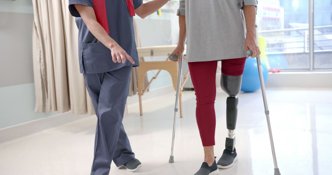 Physical Therapist Assisting Patient with Prosthetic Leg in Rehabilitation Center - Free Images, Stock Photos and Pictures on Pikwizard.com