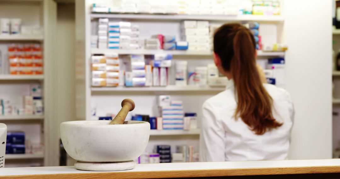 Portrait of pharmacist checking a medicine in pharmacy - Free Images, Stock Photos and Pictures on Pikwizard.com