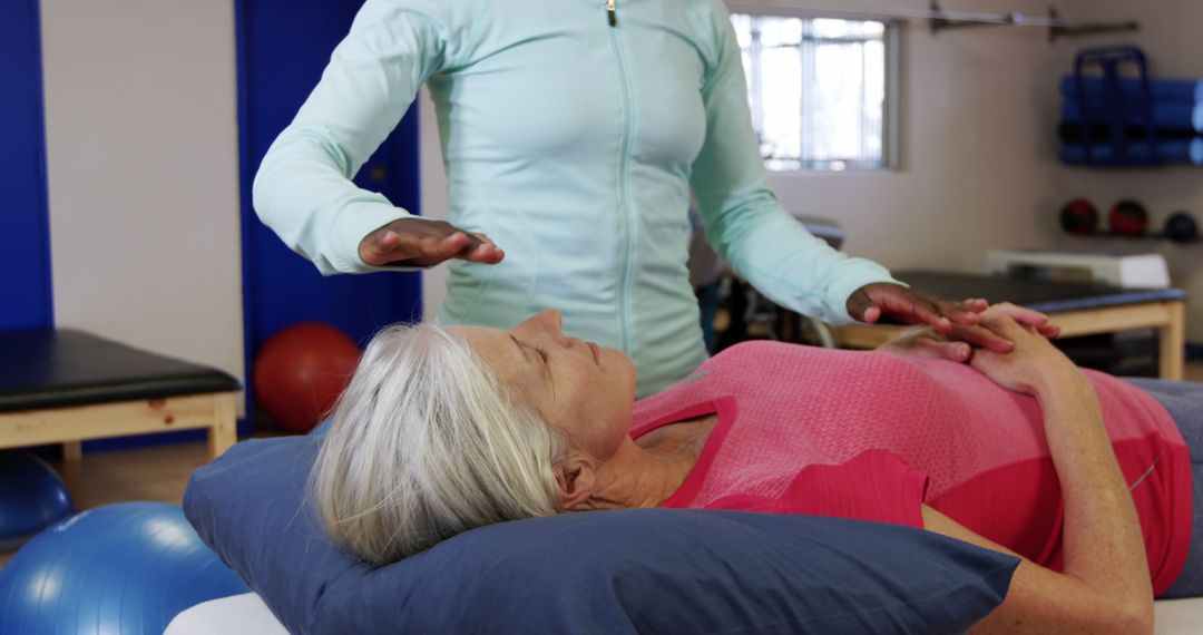 Therapist Practicing Reiki on Relaxed Elderly Woman - Free Images, Stock Photos and Pictures on Pikwizard.com