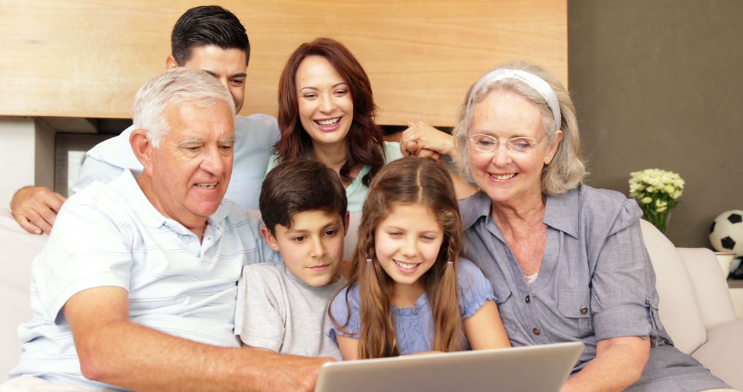 Happy Multigenerational Family Using Laptop on Couch at Home - Free Images, Stock Photos and Pictures on Pikwizard.com