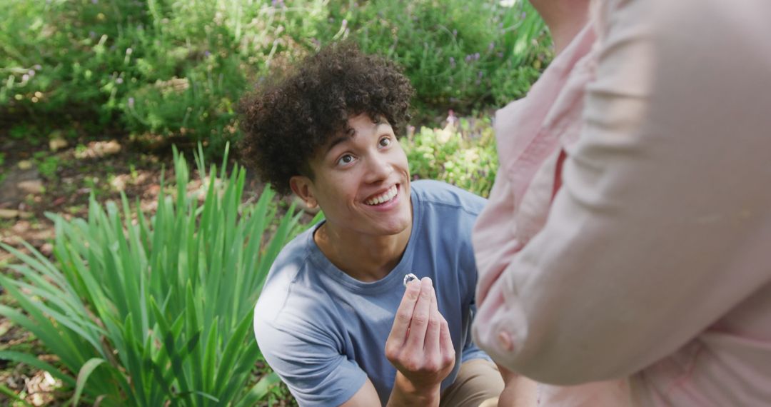 Man Proposing with Ring in Sunny Garden
