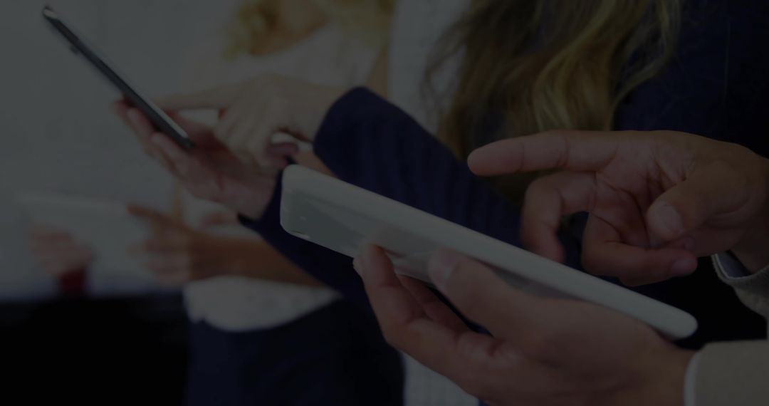 Professionals Utilizing Mobile Devices in Modern Office Collaboration