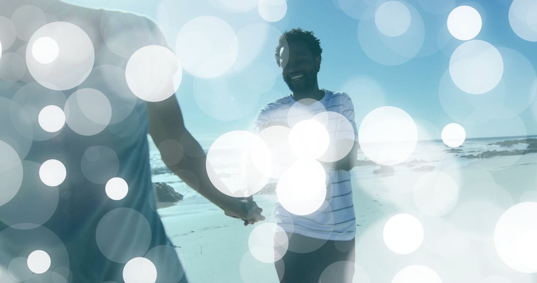 Smiling Couple Holding Hands on Sunny Beach with Soft Light Flares