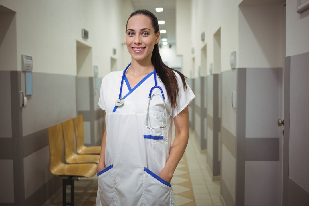 Portrait of female nurse standing in corridor - Free Images, Stock Photos and Pictures on Pikwizard.com