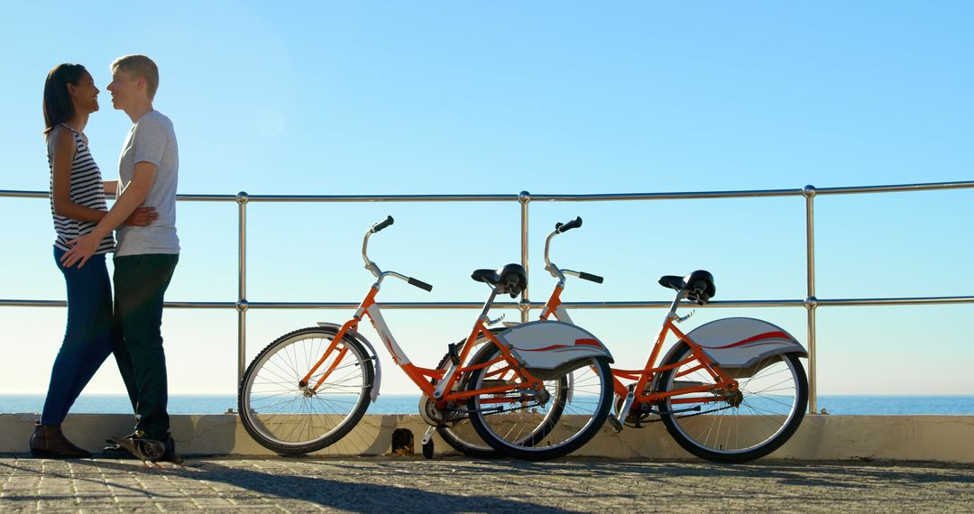 A couple shares a seaside embrace after a bike ride, with space for text. - Free Images, Stock Photos and Pictures on Pikwizard.com
