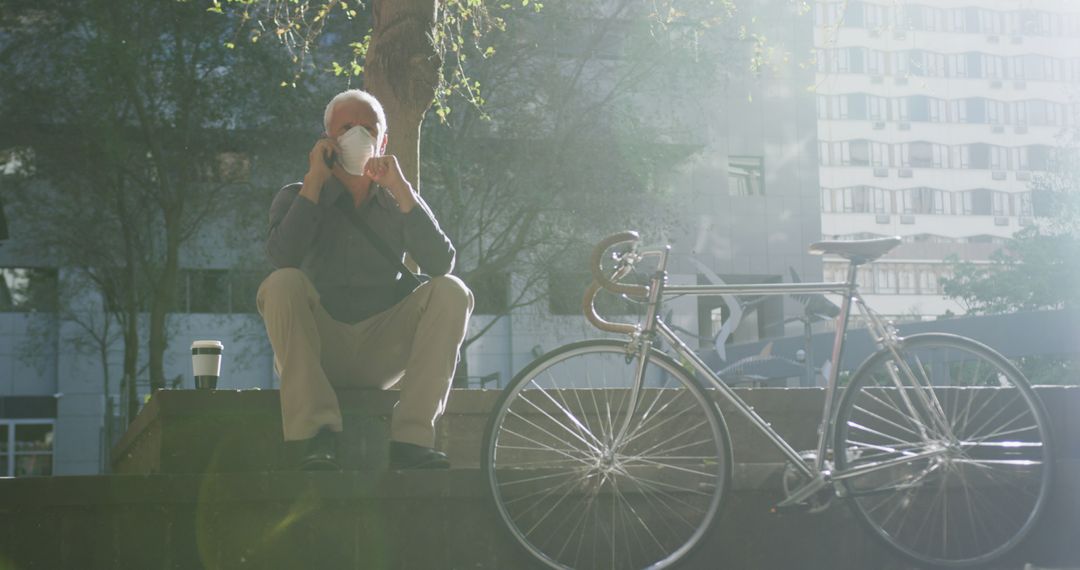 Senior Man Bicyclist Taking a Phone Call in Urban Setting - Free Images, Stock Photos and Pictures on Pikwizard.com