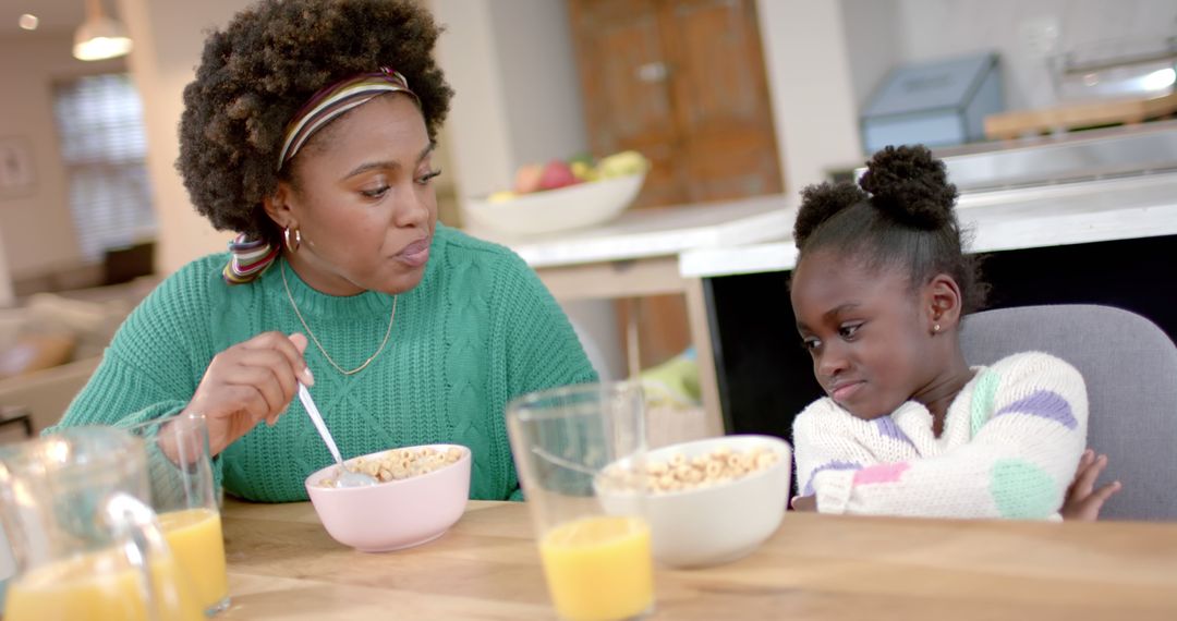 Mother and Daughter Having Breakfast with Cereals on Table - Free Images, Stock Photos and Pictures on Pikwizard.com