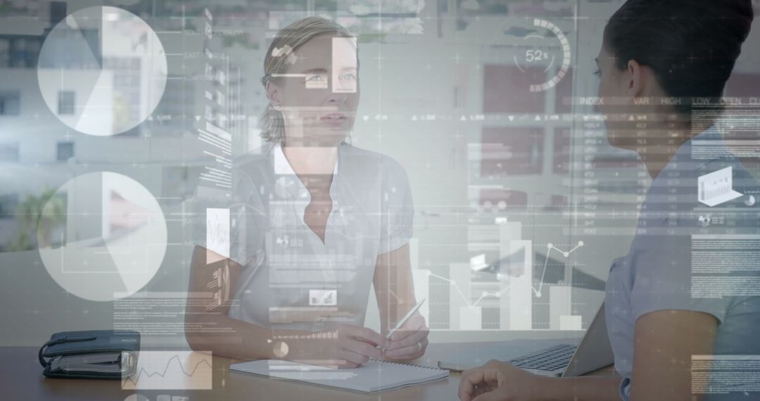 Businesswomen Analyzing Financial Data with Graphical Interface