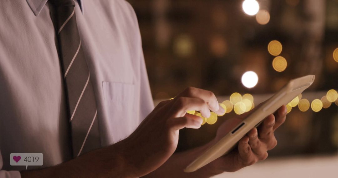 Businessman Using Tablet with Warm Ambient Lighting