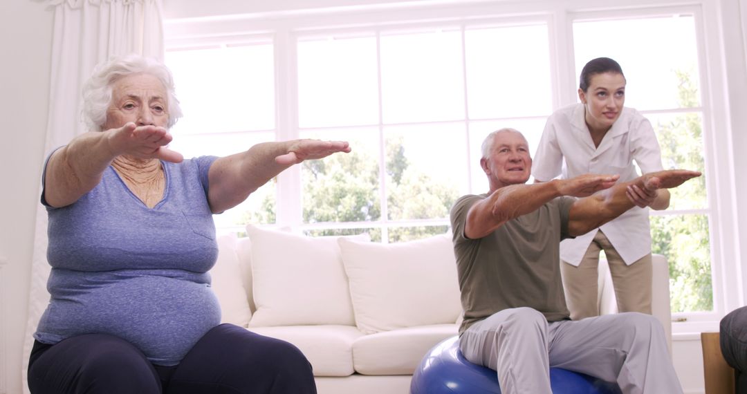 Smiling Caregiver Assisting Senior Couple with Home Exercises - Free Images, Stock Photos and Pictures on Pikwizard.com