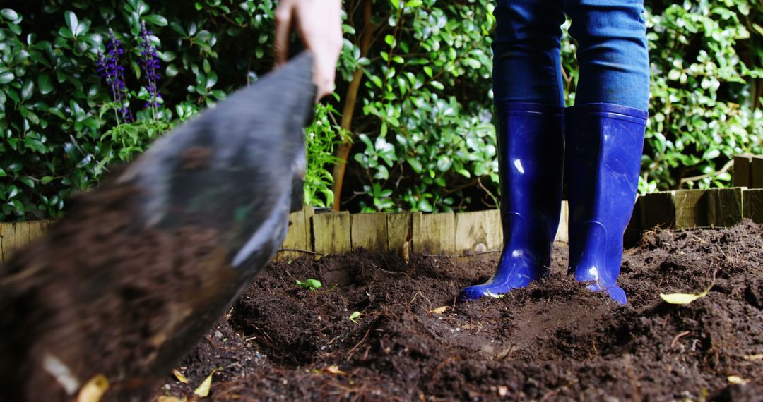 Person Using Shovel in Garden with Blue Boots - Free Images, Stock Photos and Pictures on Pikwizard.com