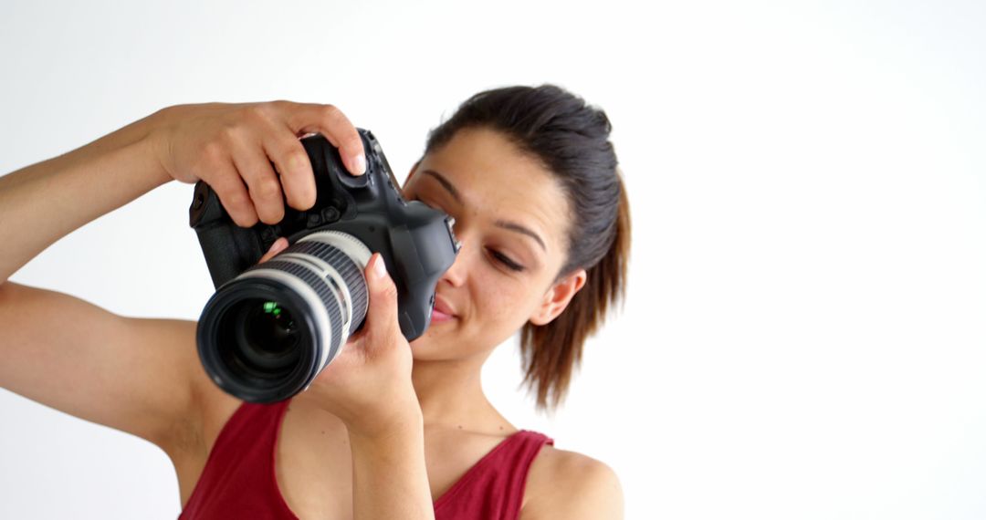 Female Photographer Adjusting DSLR Camera with Lens - Free Images, Stock Photos and Pictures on Pikwizard.com