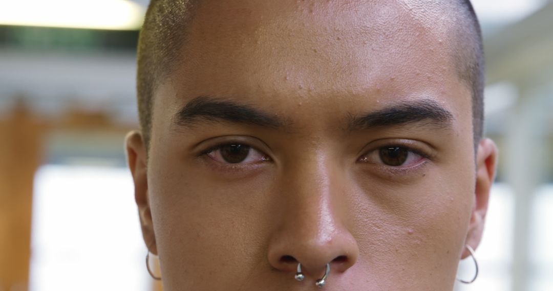 Close-up of a young biracial man with a nose piercing, with copy space - Free Images, Stock Photos and Pictures on Pikwizard.com