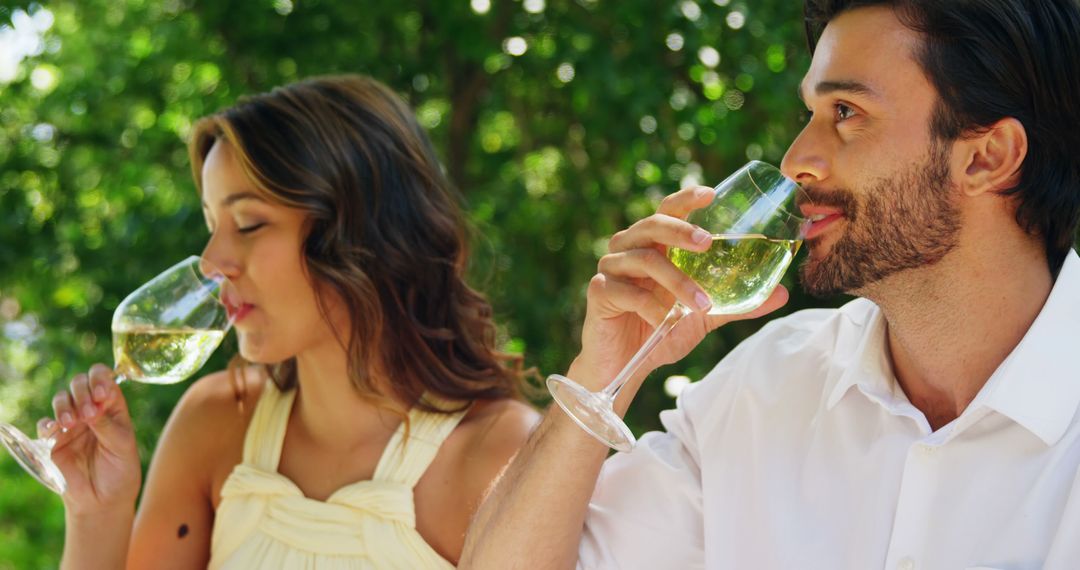 Couple Enjoying Refreshing White Wine in Outdoor Setting - Free Images, Stock Photos and Pictures on Pikwizard.com