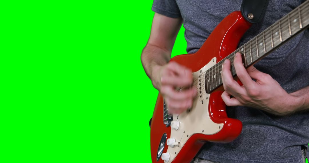 Mid section of male musician playing guitar against green screen - Free Images, Stock Photos and Pictures on Pikwizard.com