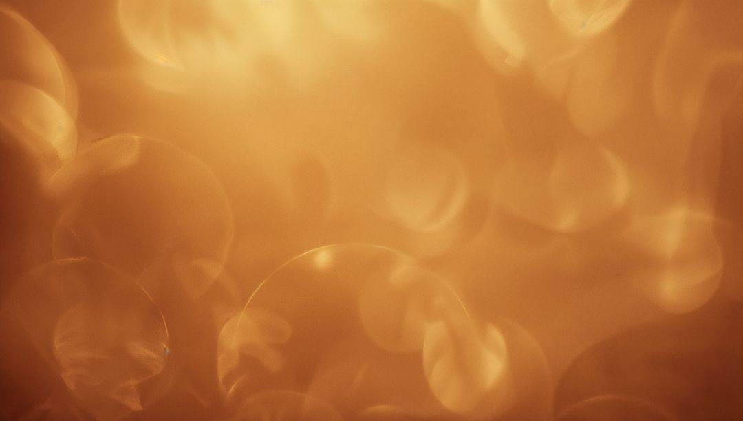 Glowing Golden Bokeh Orbs Abstract Background with Soft Amber Light and Circular Bloom