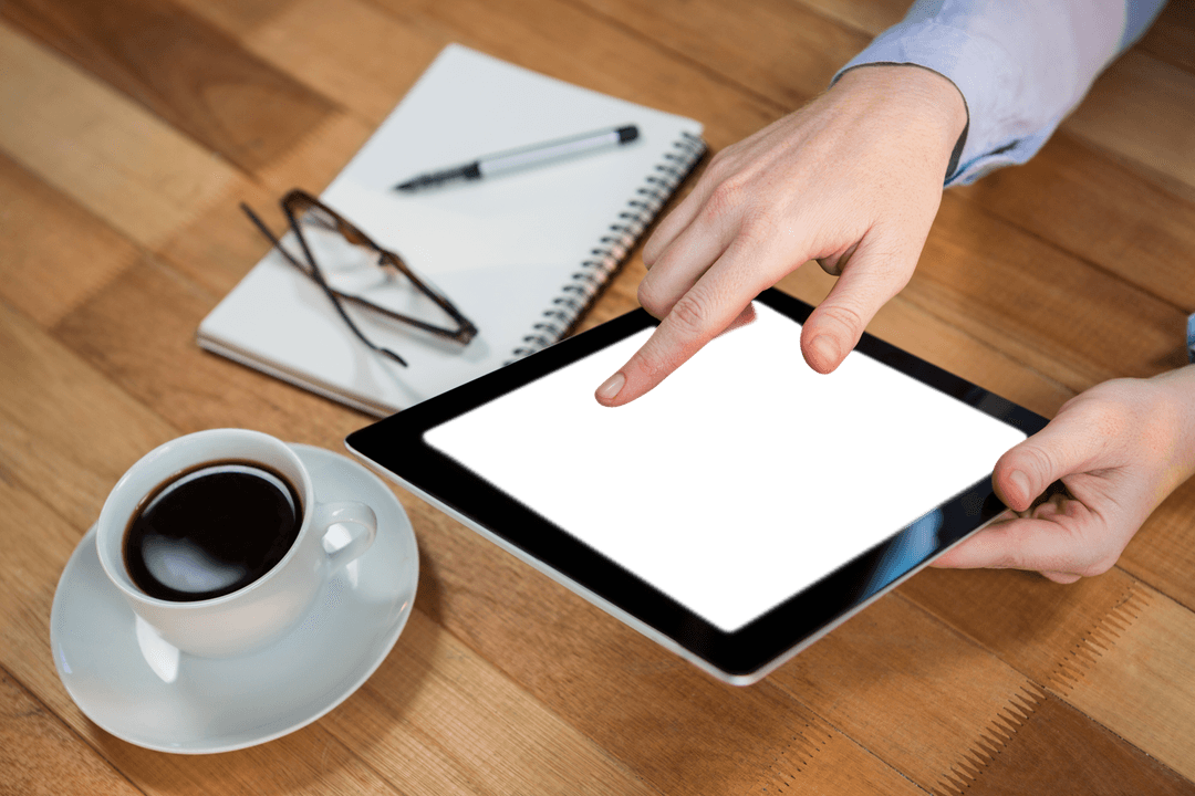 Hand Using Transparent Digital Tablet in Coffee Shop Setting