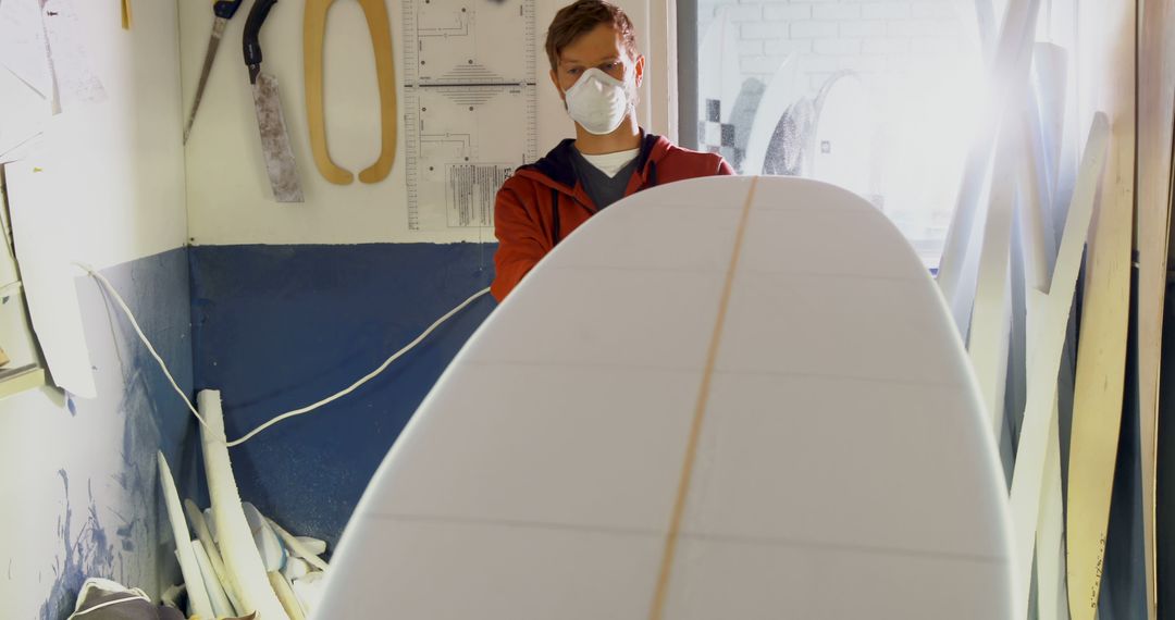 Worker Shaping Surfboard in Workshop - Free Images, Stock Photos and Pictures on Pikwizard.com