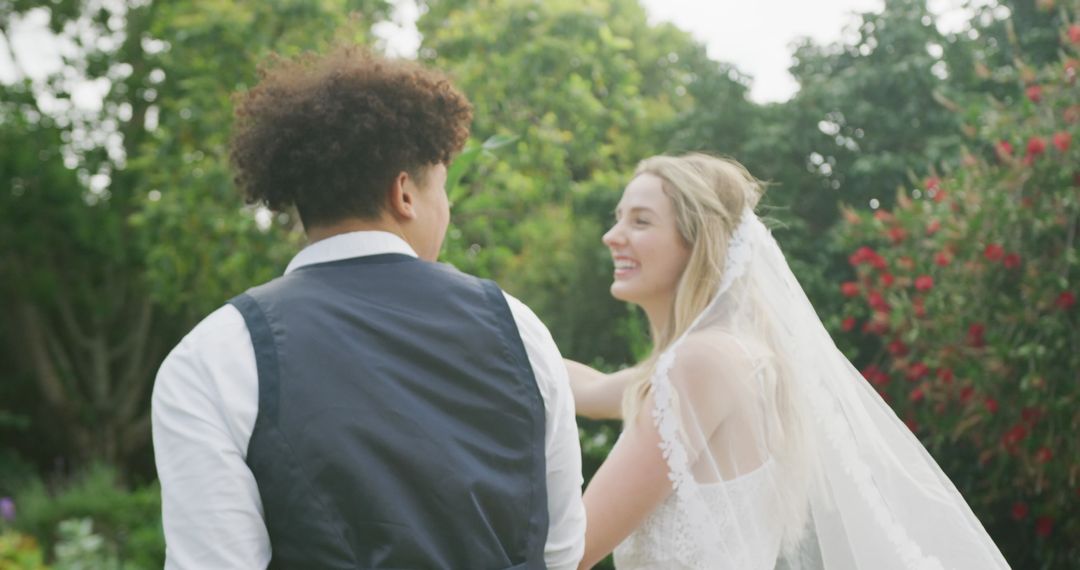Happy Couple Walking in Garden at Outdoor Wedding Ceremony