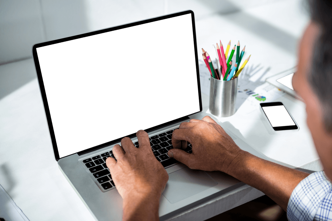 Transparent View of Man Typing on Laptop at Desk with Colorful Pencils