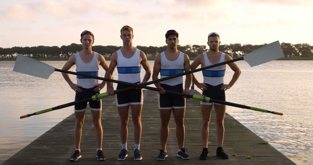 Competitive Male Rowers Holding Oars on Dock at Sunset - Free Images, Stock Photos and Pictures on Pikwizard.com