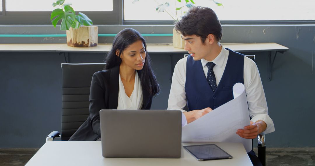 Colleagues Collaborating on Business Strategy in Modern Office