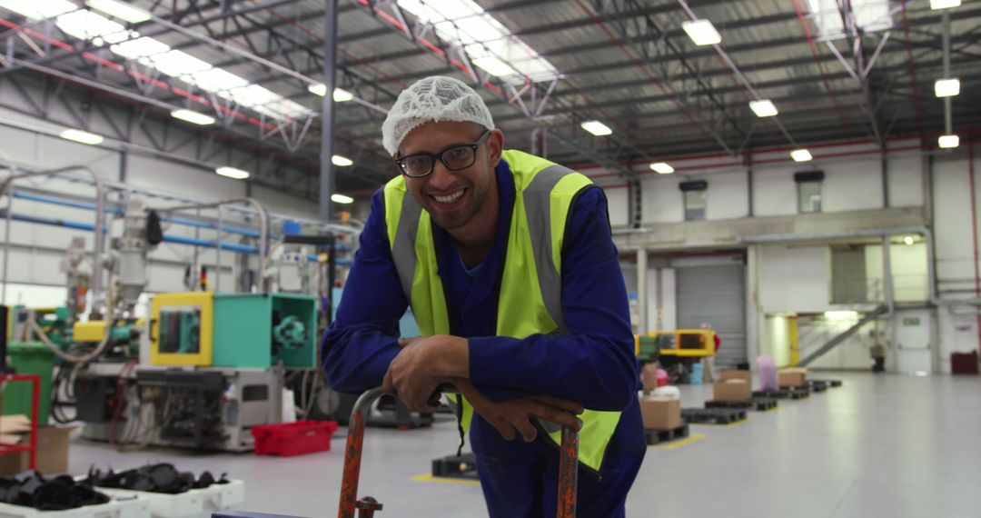 Worker Smiling in Factory Wearing Safety Vest and Hair Net - Free Images, Stock Photos and Pictures on Pikwizard.com